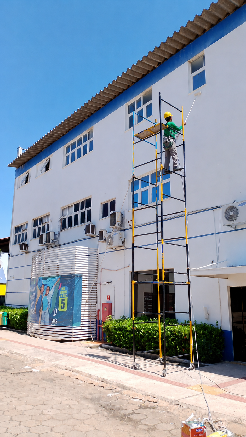 Obra em execução com trabalhador em andaime